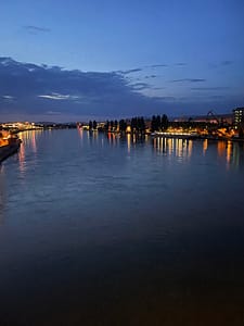 the Rhine river at night with lights from the city